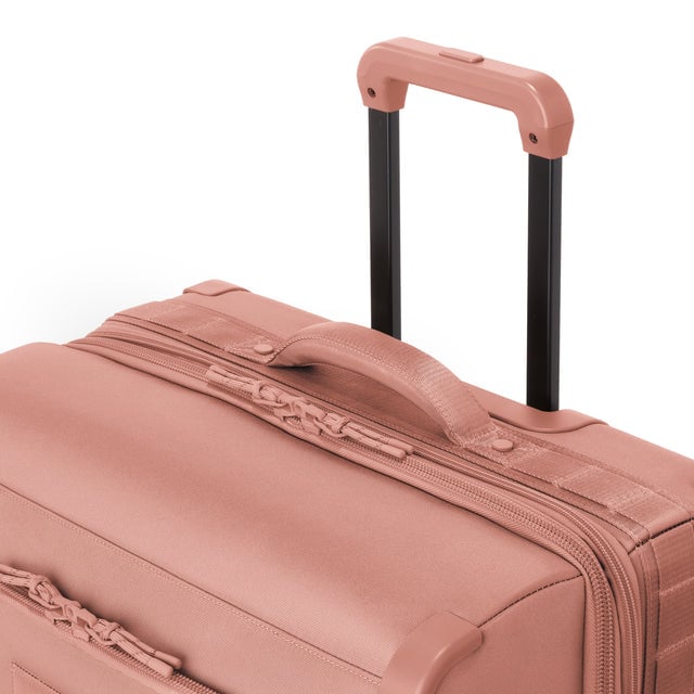 Detail shot of Sydney checked rolling luggage 25” in warm dust extended luggage handle and puffy handle