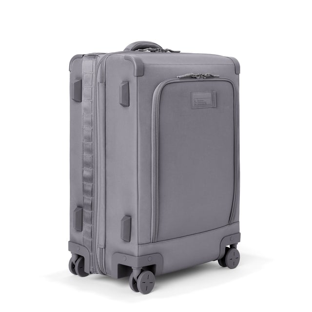 3/4 front view of Sydney checked rolling luggage 25” in ash grey showing side luggage feet