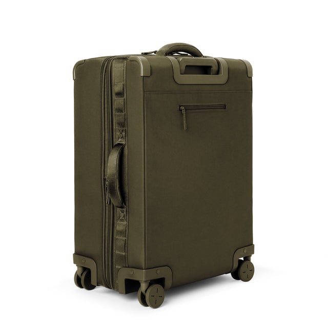 3/4 back view of Sydney checked rolling luggage 25” in dark moss showing side handle and back zippered phone/passport pocket