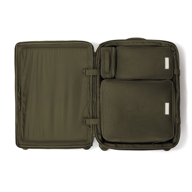Top down of Sydney checked rolling luggage 25” in dark moss with interior divider zipped and packing cubes packed into the right side. hover