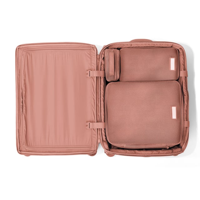 Top down of Sydney checked rolling luggage 25” in warm dust with interior divider zipped and packing cubes packed into the right side. hover