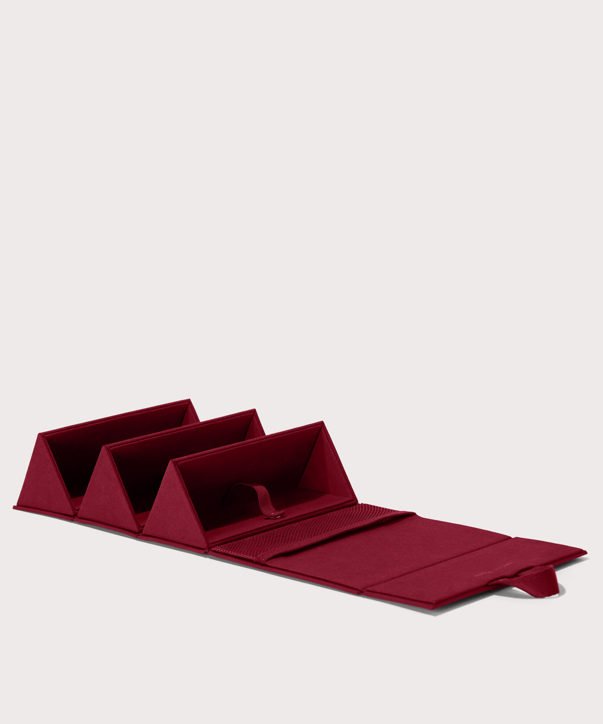 Dagne Dover Remi foldable glasses holder in spice red, unfolded.
