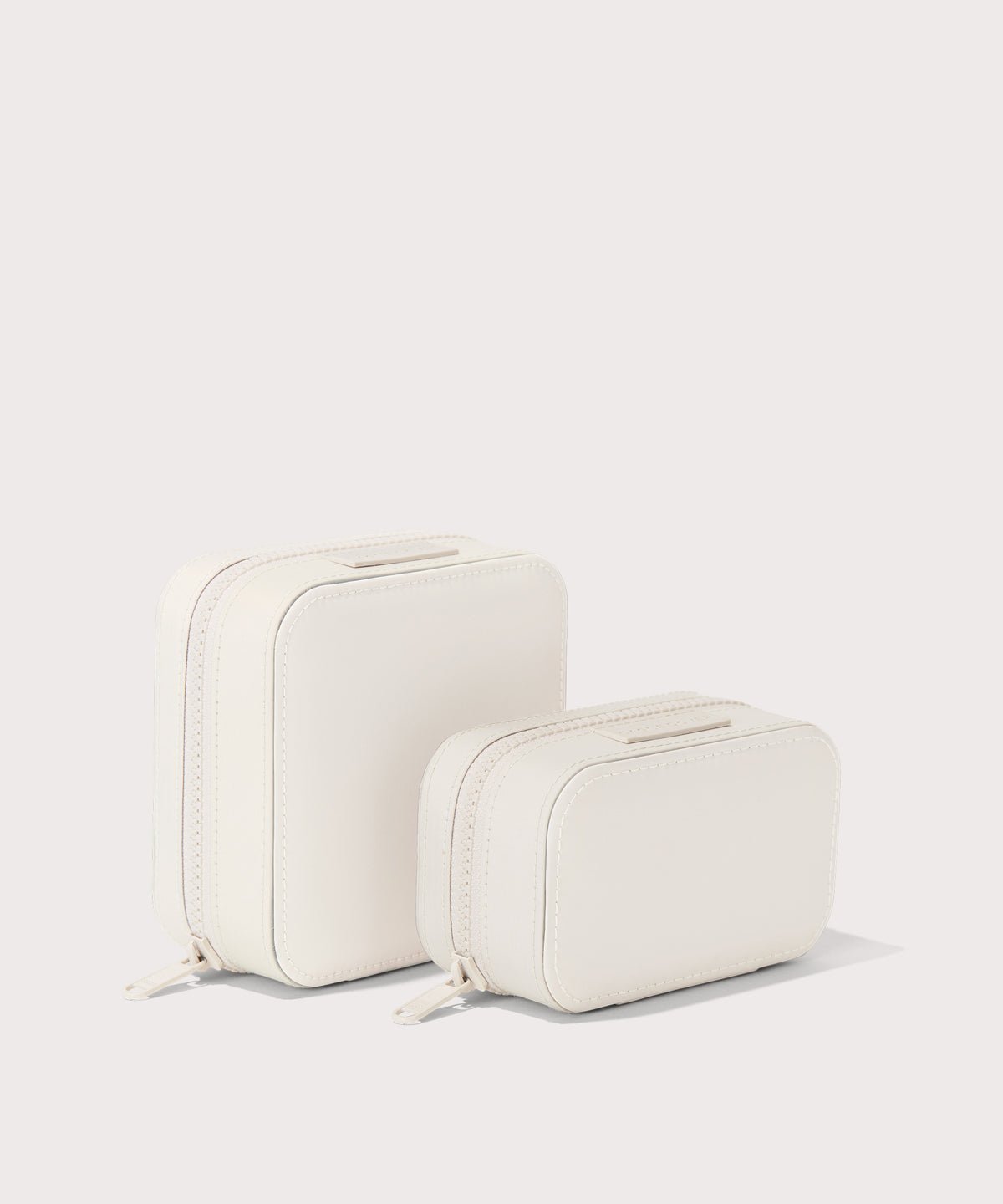Dagne Dover Small and small Frankie Jewelry Cases in white standing next to one another.
