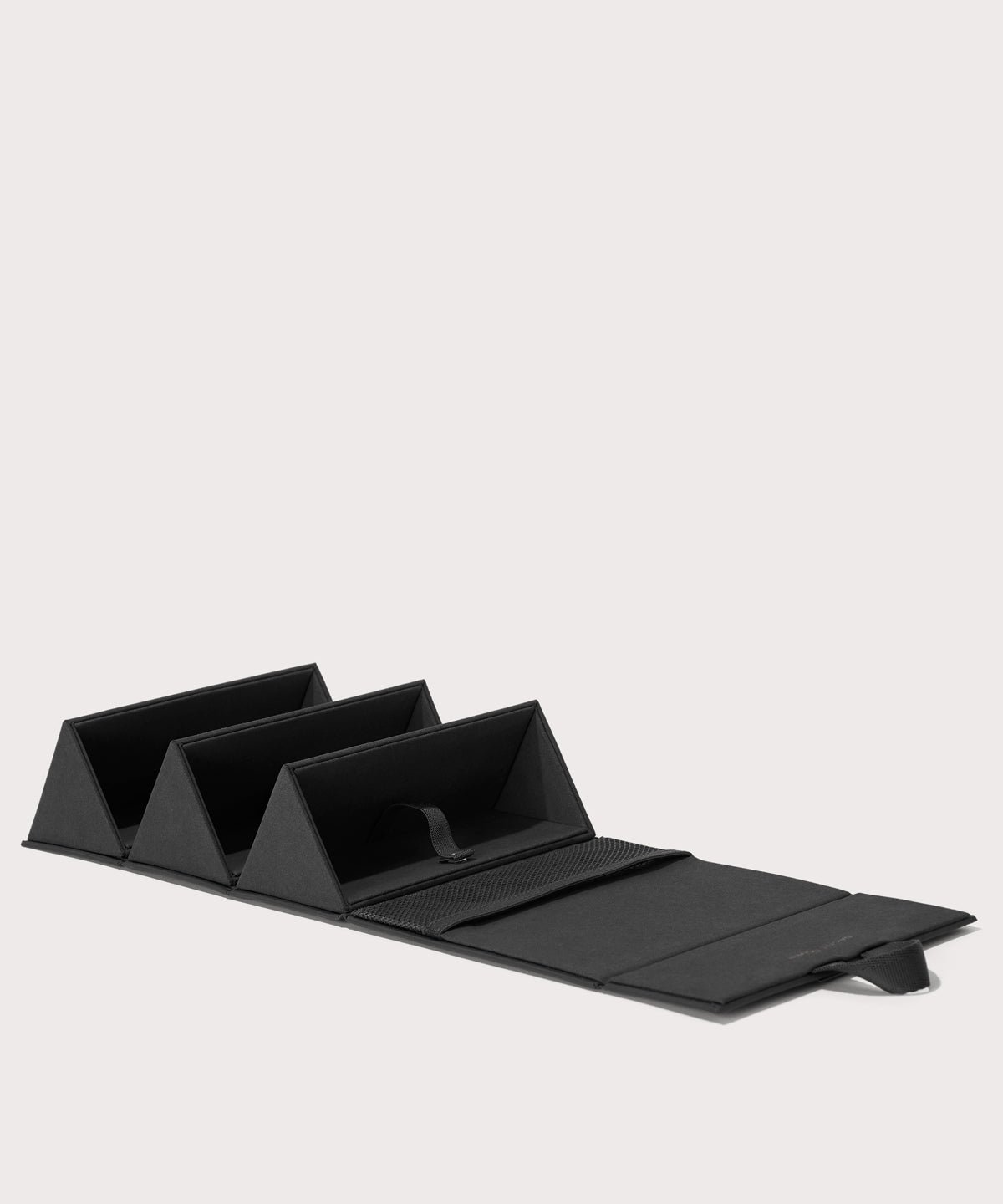 Dagne Dover Remi foldable glasses holder in black, unfolded.
