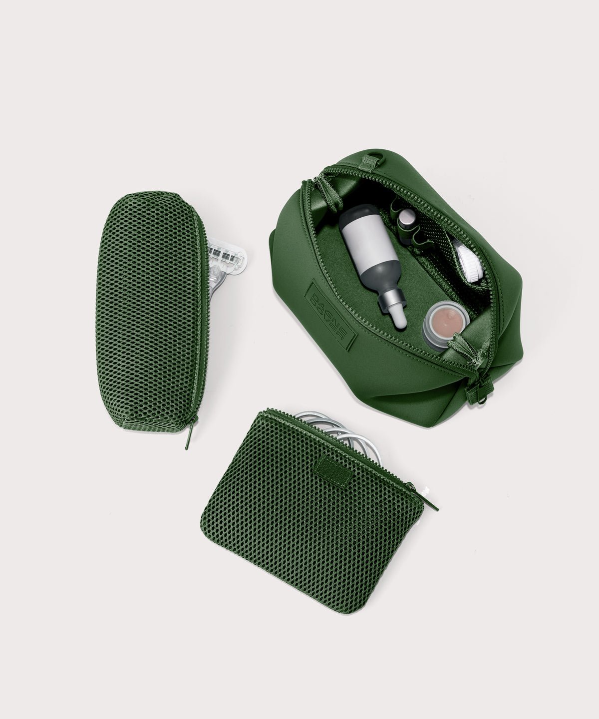 Dagne Dover Large Hunter Toiletry Bag in a rich, classic forest green. unzipped and seen from above with the removable air mesh pouch alongside it.