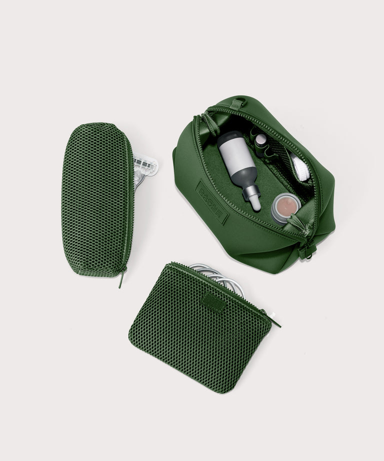 Dagne Dover Large Hunter Toiletry Bag in a rich, classic forest green. unzipped and seen from above with the removable air mesh pouch alongside it.