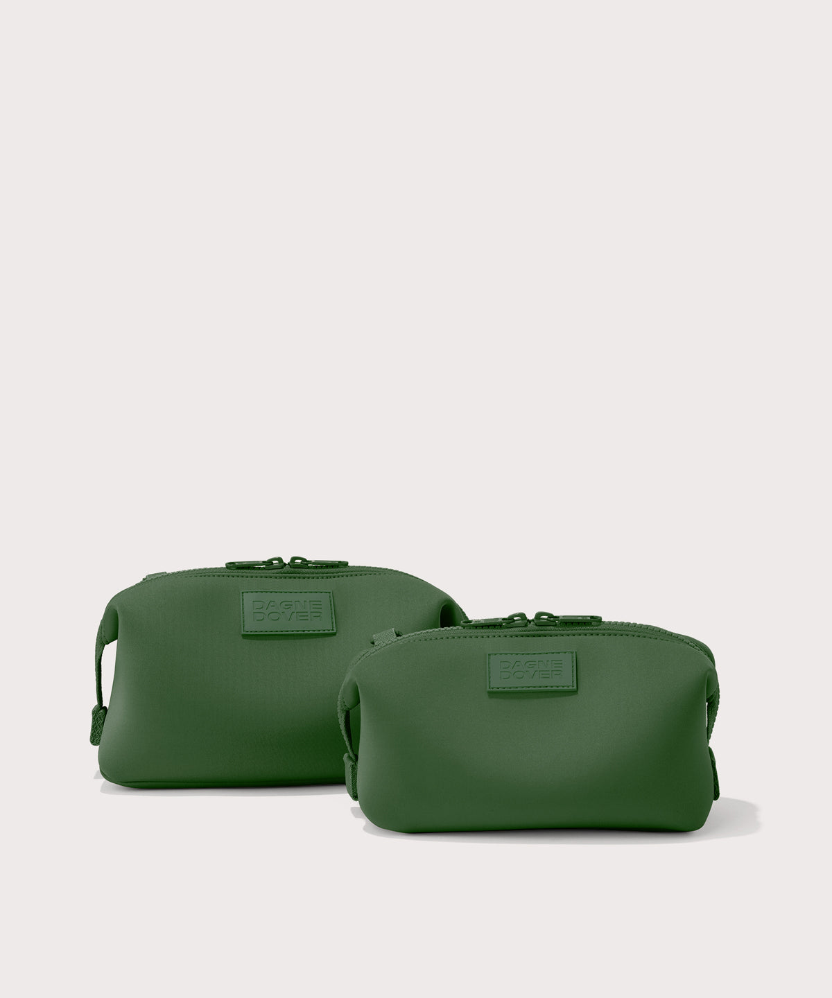 Dagne Dover Small and Large Hunter Toiletry Bags in a rich, classic forest green.
