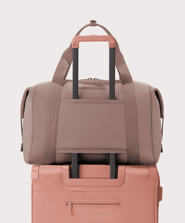 Extra large Landon Carryall in pink displaying luggage sleeve
