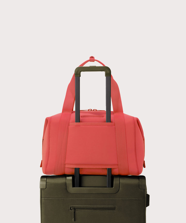 Large Landon Carryall in a poppy, vintage wash red displaying luggage sleeve
