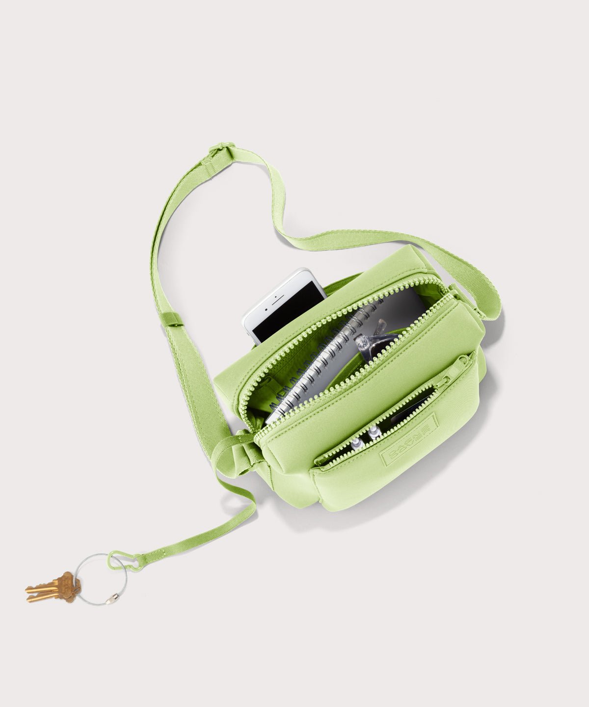 Dagne Dover Micah Crossbody in matcha seen from above, showing the interior air mesh pocket.