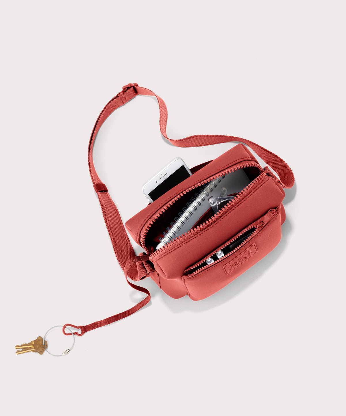 Dagne Dover Micah Crossbody in a poppy, vintage wash red seen from above, showing the interior air mesh pocket.