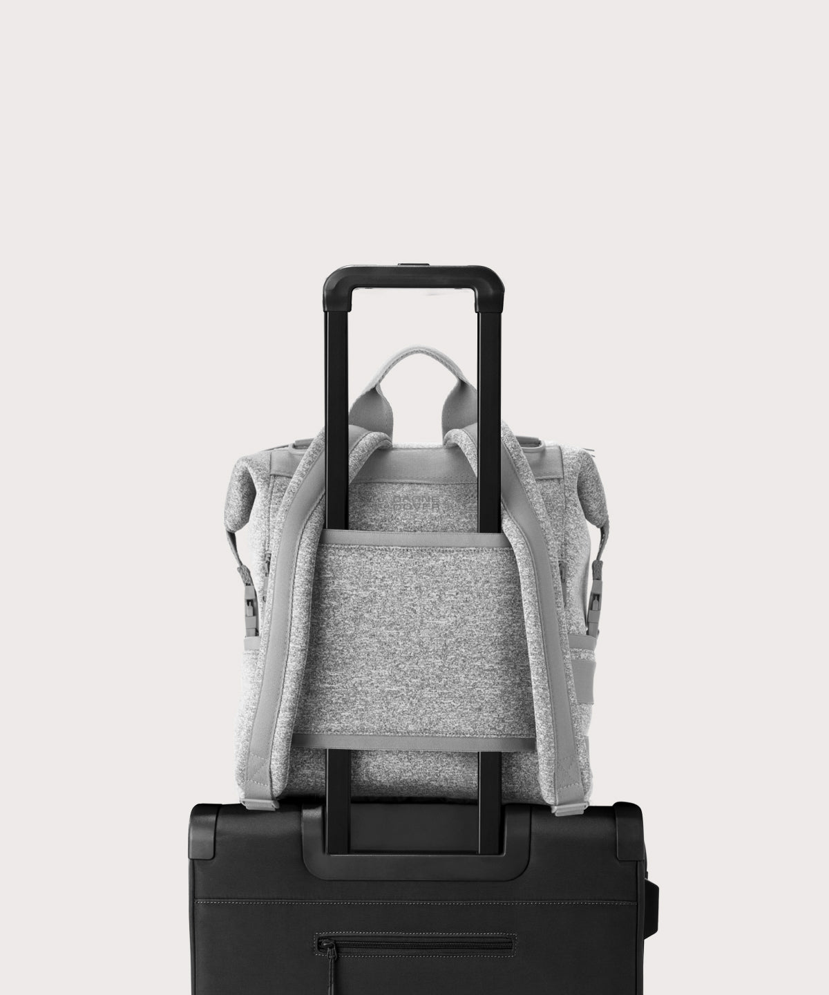 Dagne Dover medium Indi Diaper Backpack in grey showing the neoprene luggage sleeve.

