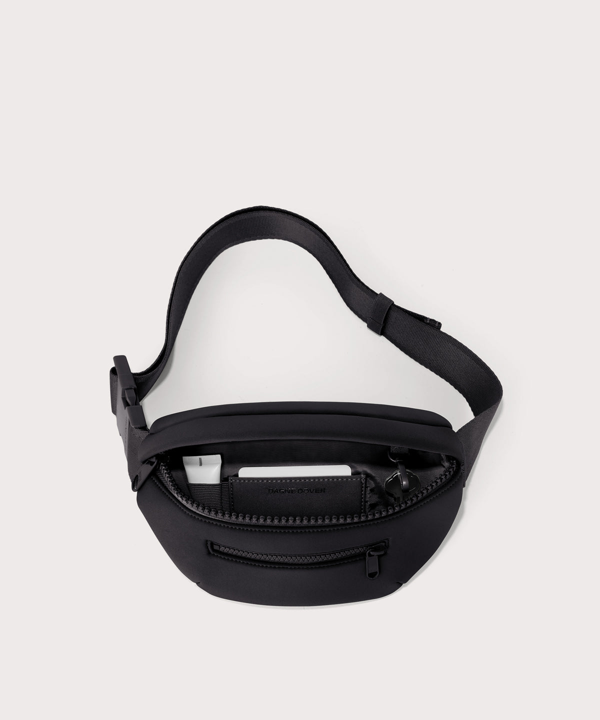 Dagne Dover Ace Fanny Pack in black  unzipped, exposing the interior pockets
