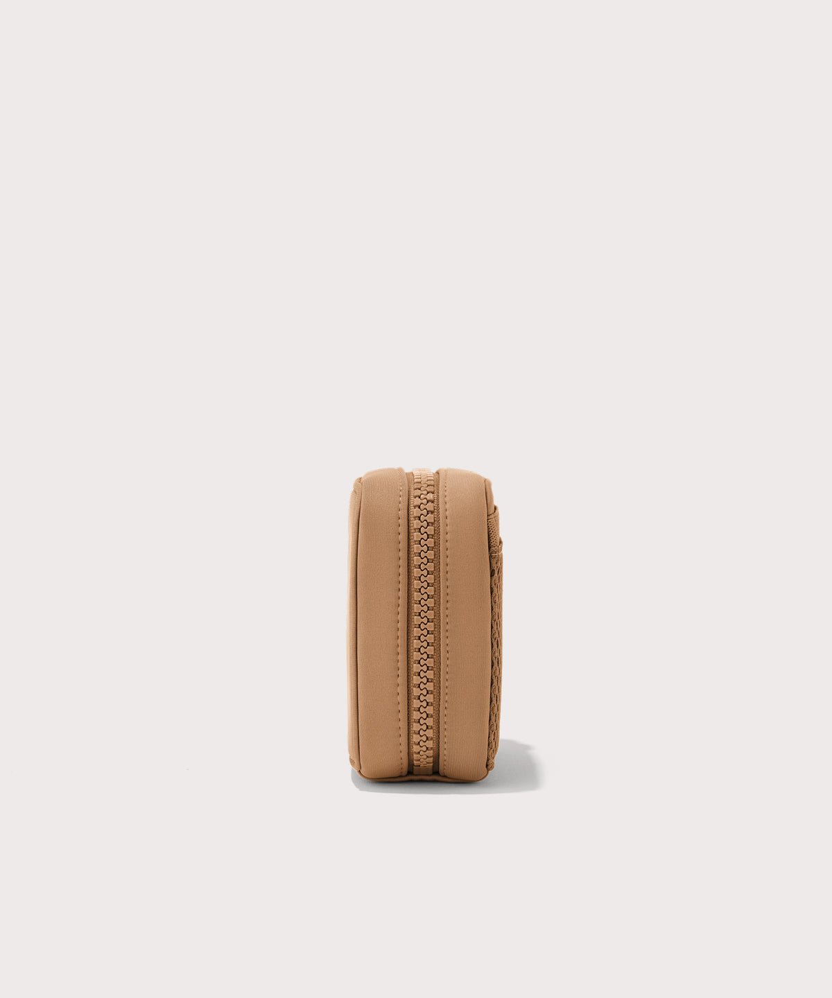 Dagne Dover small Arlo Tech Organizer in camel seen from the side.
