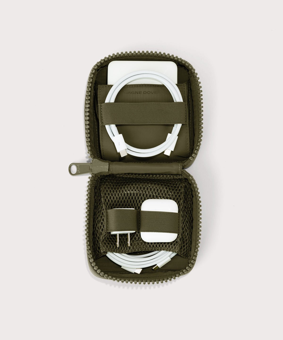Dagne Dover small Arlo Tech Organizer in dark green unzipped, revealing the interior elastic loops and airmesh pockets.