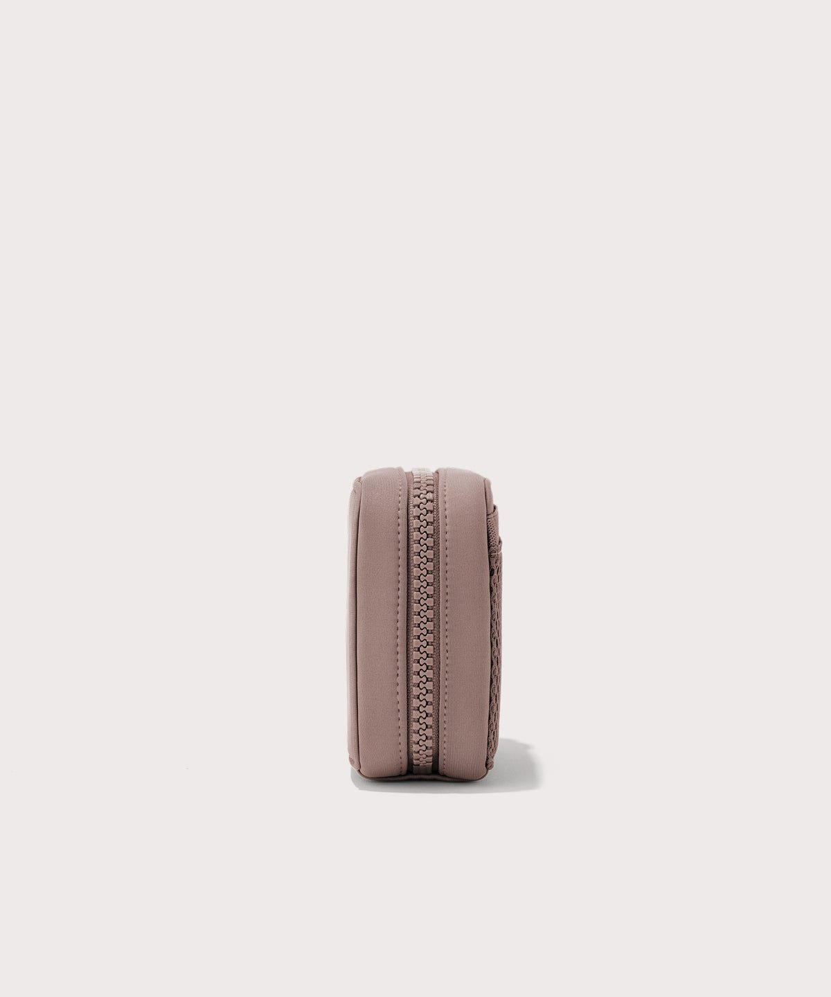 Dagne Dover small Arlo Tech Organizer in pink seen from the side.
