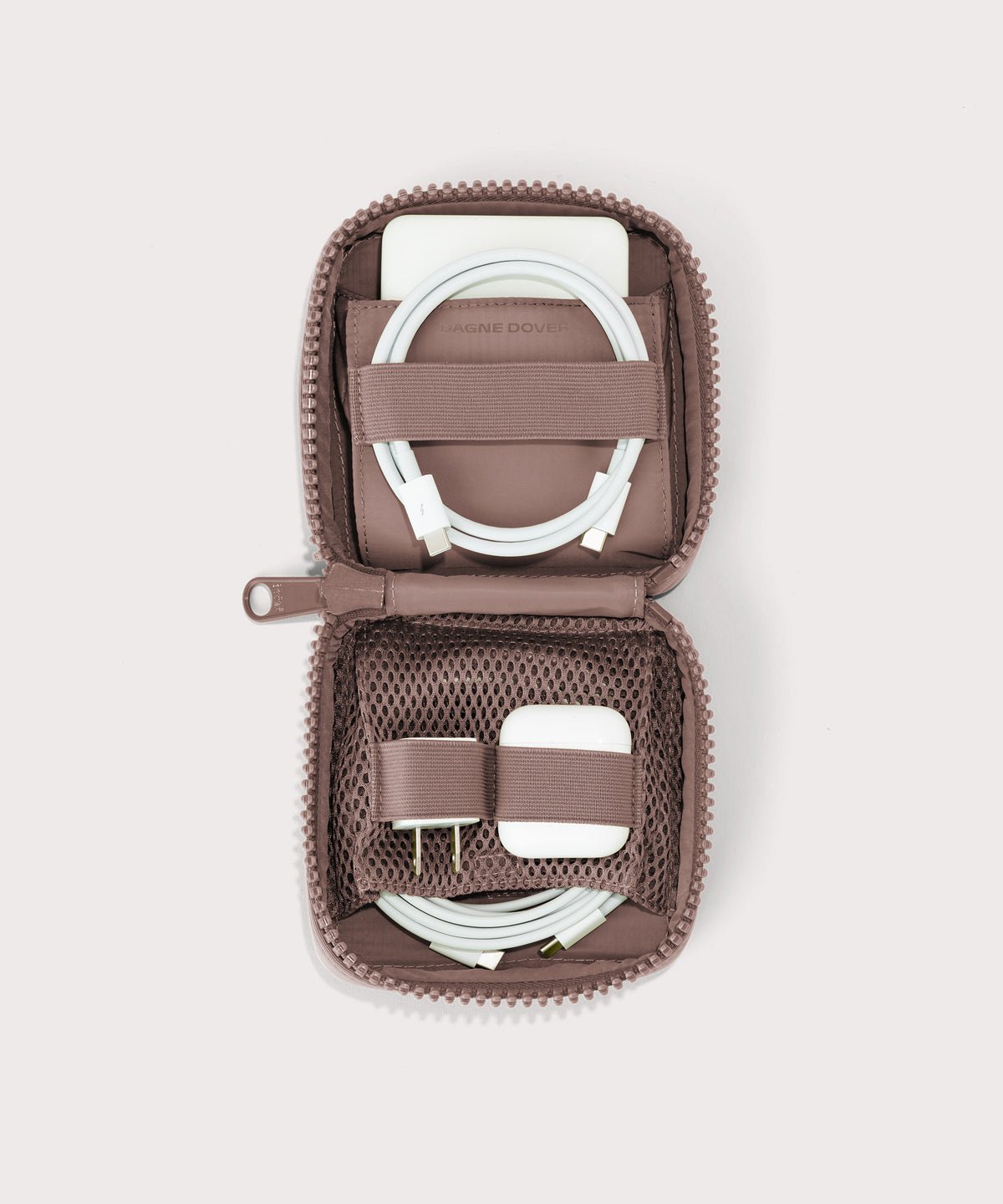 Dagne Dover small Arlo Tech Organizer in pink unzipped, revealing the interior elastic loops and airmesh pockets.