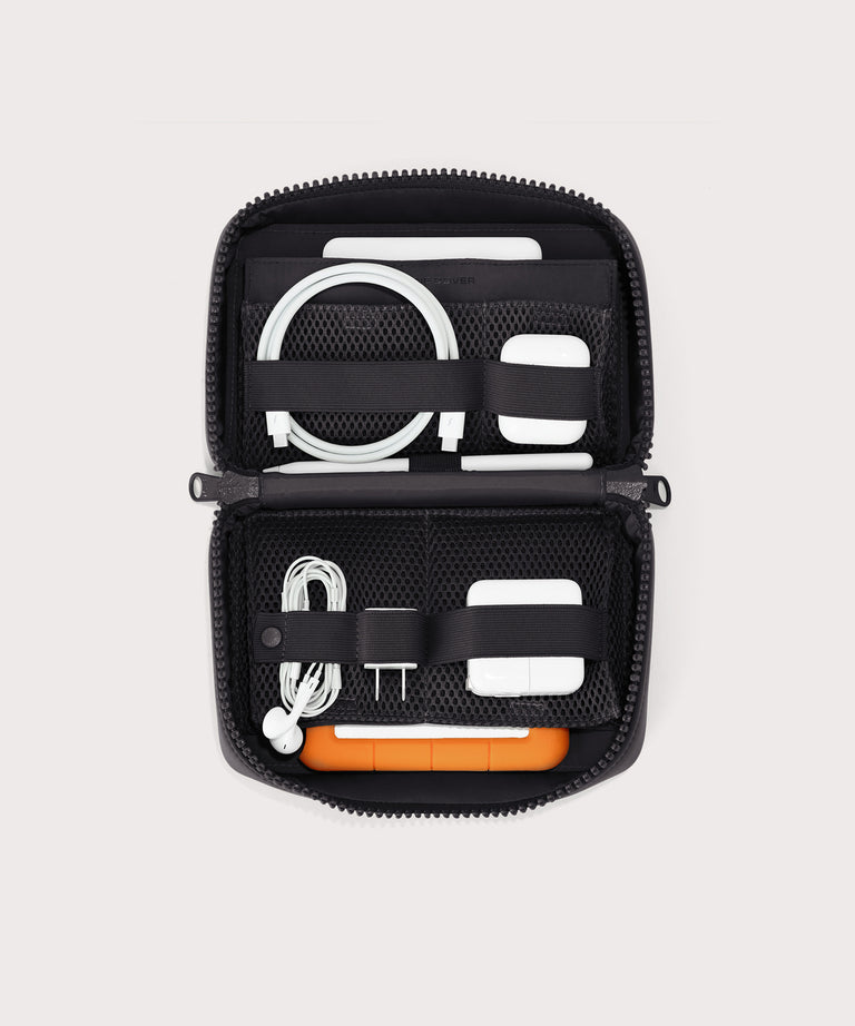 hover - Dagne Dover large Arlo Tech Organizer in black unzipped, revealing the interior elastic loops and airmesh pockets.