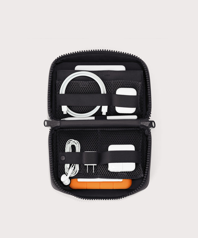 hover - Dagne Dover large Arlo Tech Organizer in black unzipped, revealing the interior elastic loops and airmesh pockets.