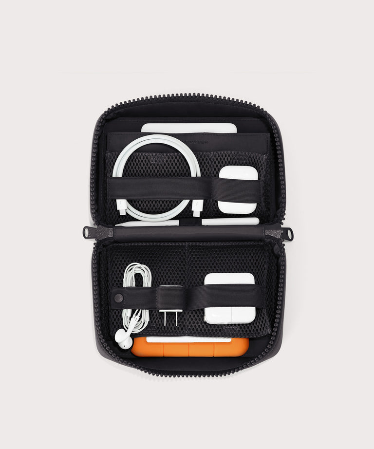 hover - Dagne Dover large Arlo Tech Organizer in black unzipped, revealing the interior elastic loops and airmesh pockets.