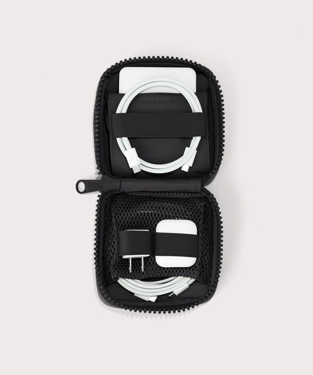Dagne Dover small Arlo Tech Organizer in black unzipped, revealing the interior elastic loops and airmesh pockets.