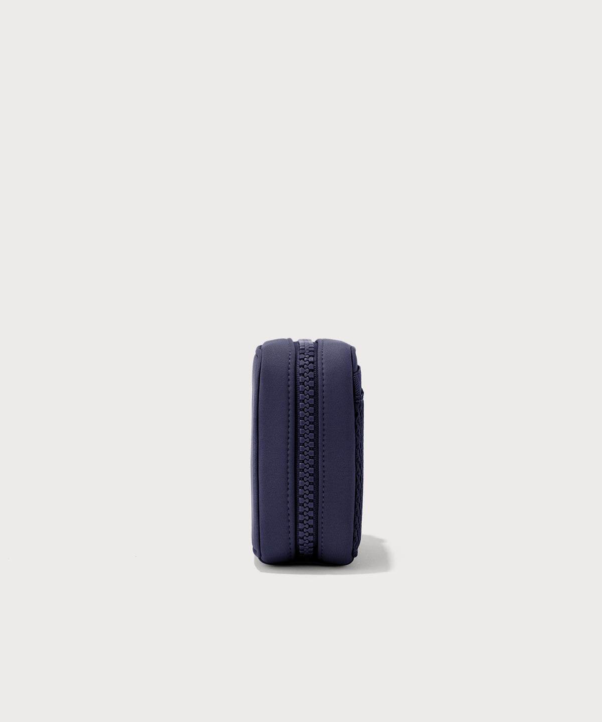Dagne Dover small Arlo Tech Organizer in  dark blue seen from the side.
