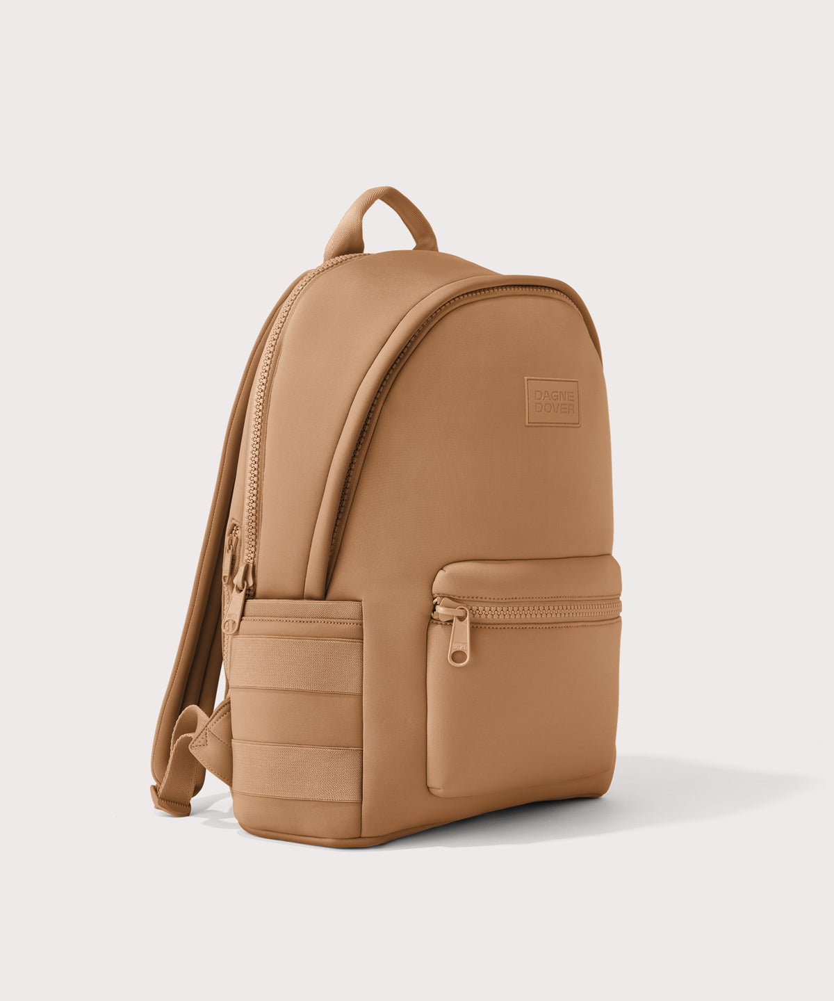 Dagne Dover large Dakota Neoprene Backpack in camel seen from an angle.
