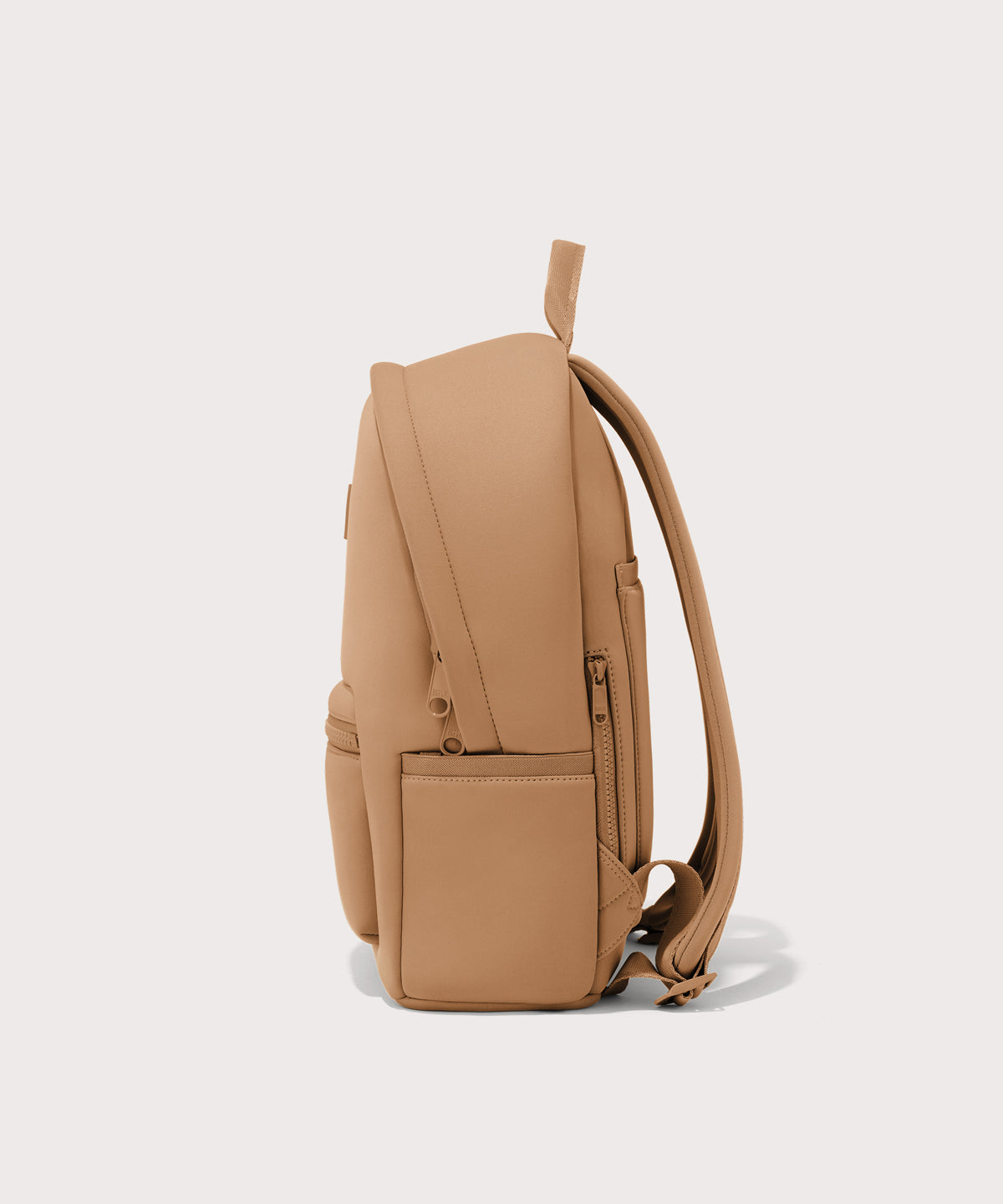 Dagne Dover medium Dakota Neoprene Backpack in camel brown seen from the side.
