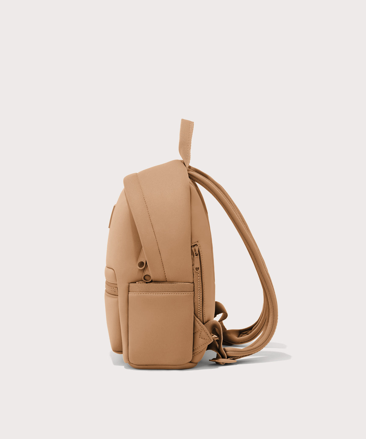 Dagne Dover small Dakota Neoprene Backpack in camel seen from the side.
