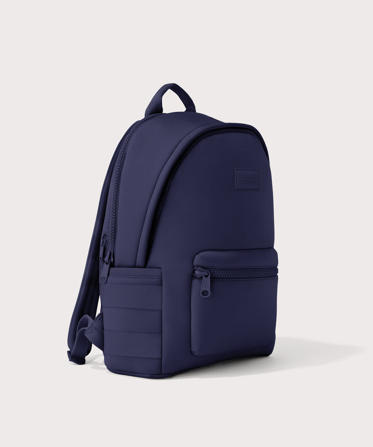 Dagne Dover large Dakota Neoprene Backpack in dark blue seen from an angle.
