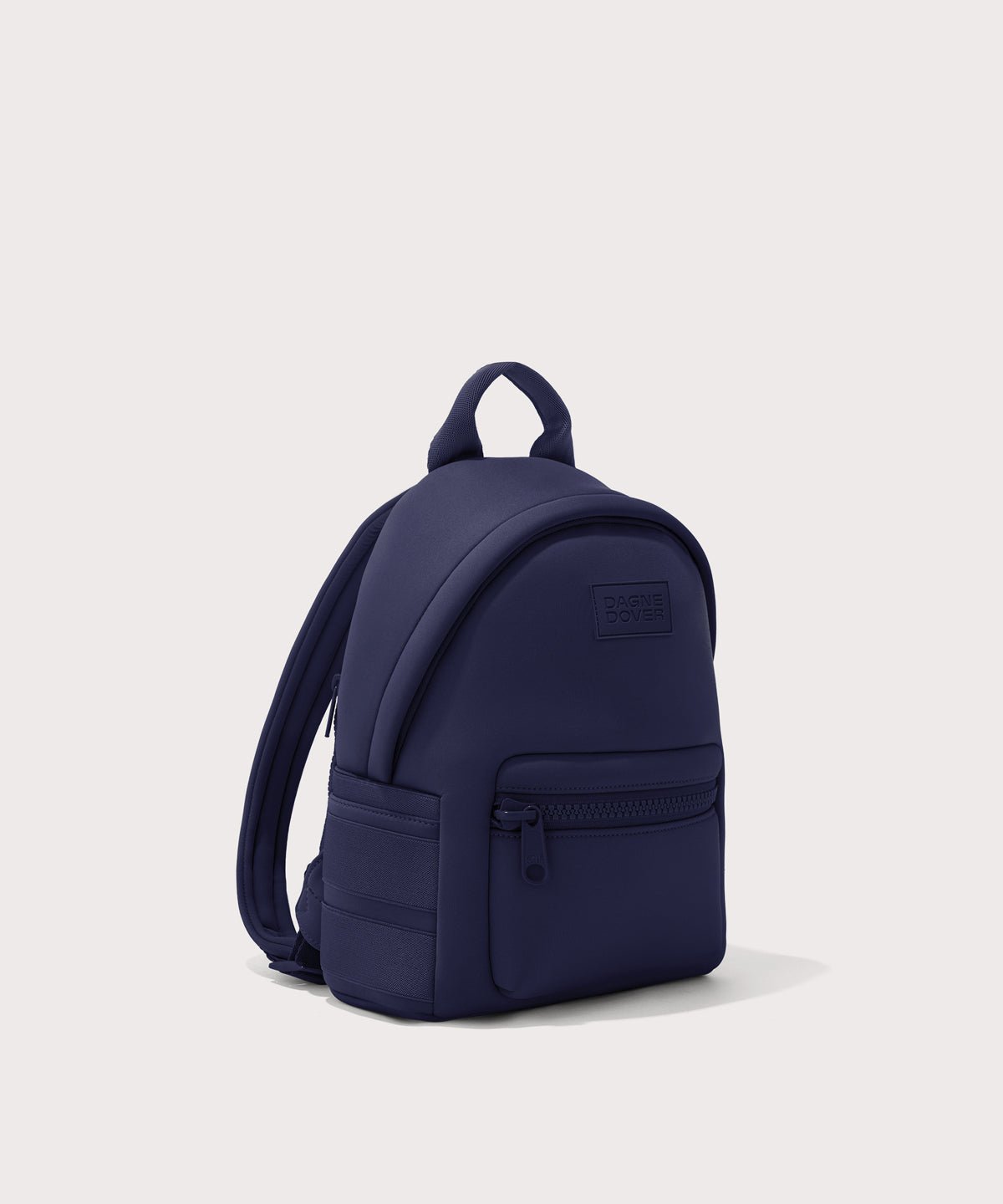 Dagne Dover small Dakota Neoprene Backpack in dark blue seen from an angle.
