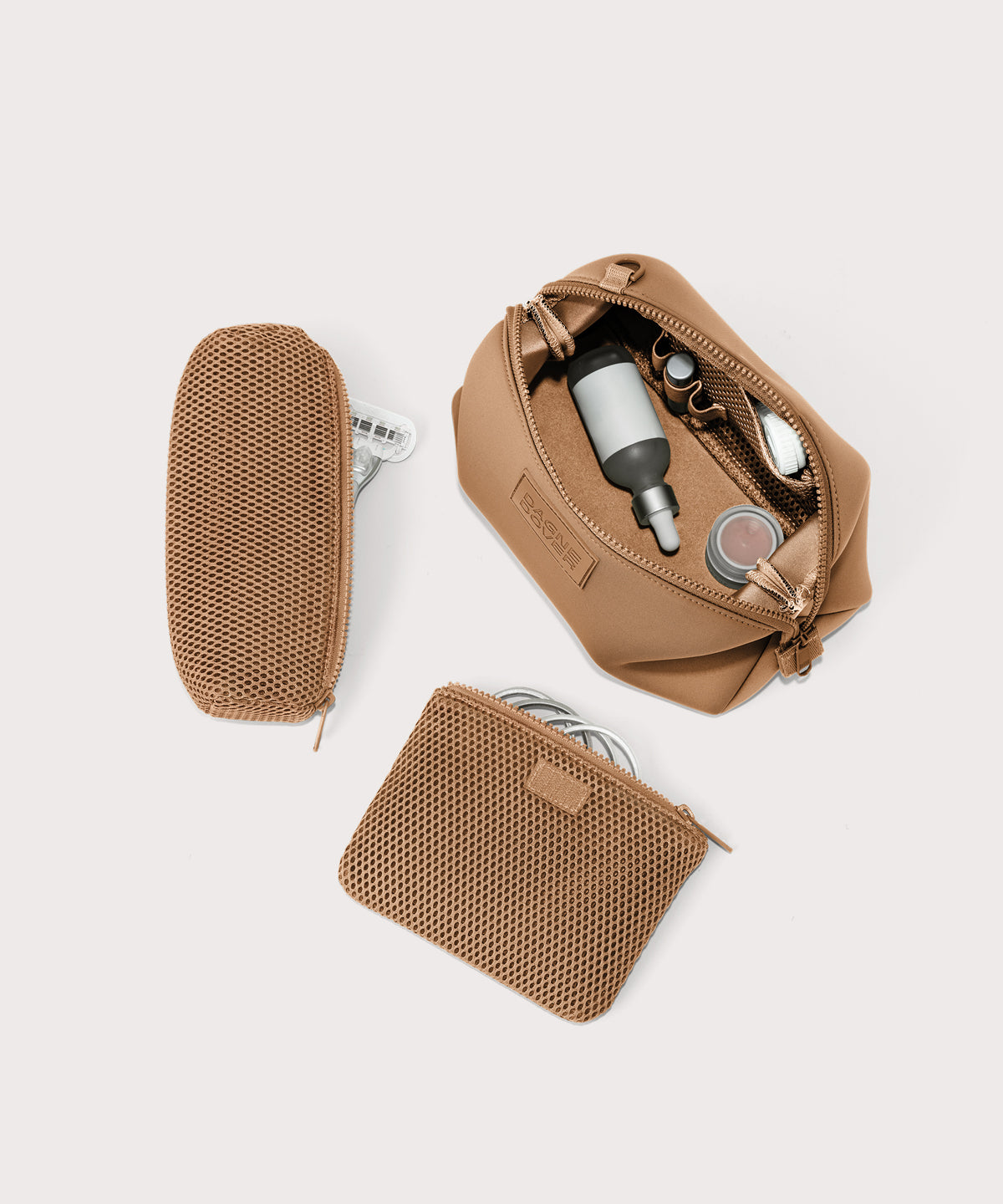 Dagne Dover Large Hunter Toiletry Bag in camel brown unzipped and seen from above with the removable air mesh pouch alongside it.