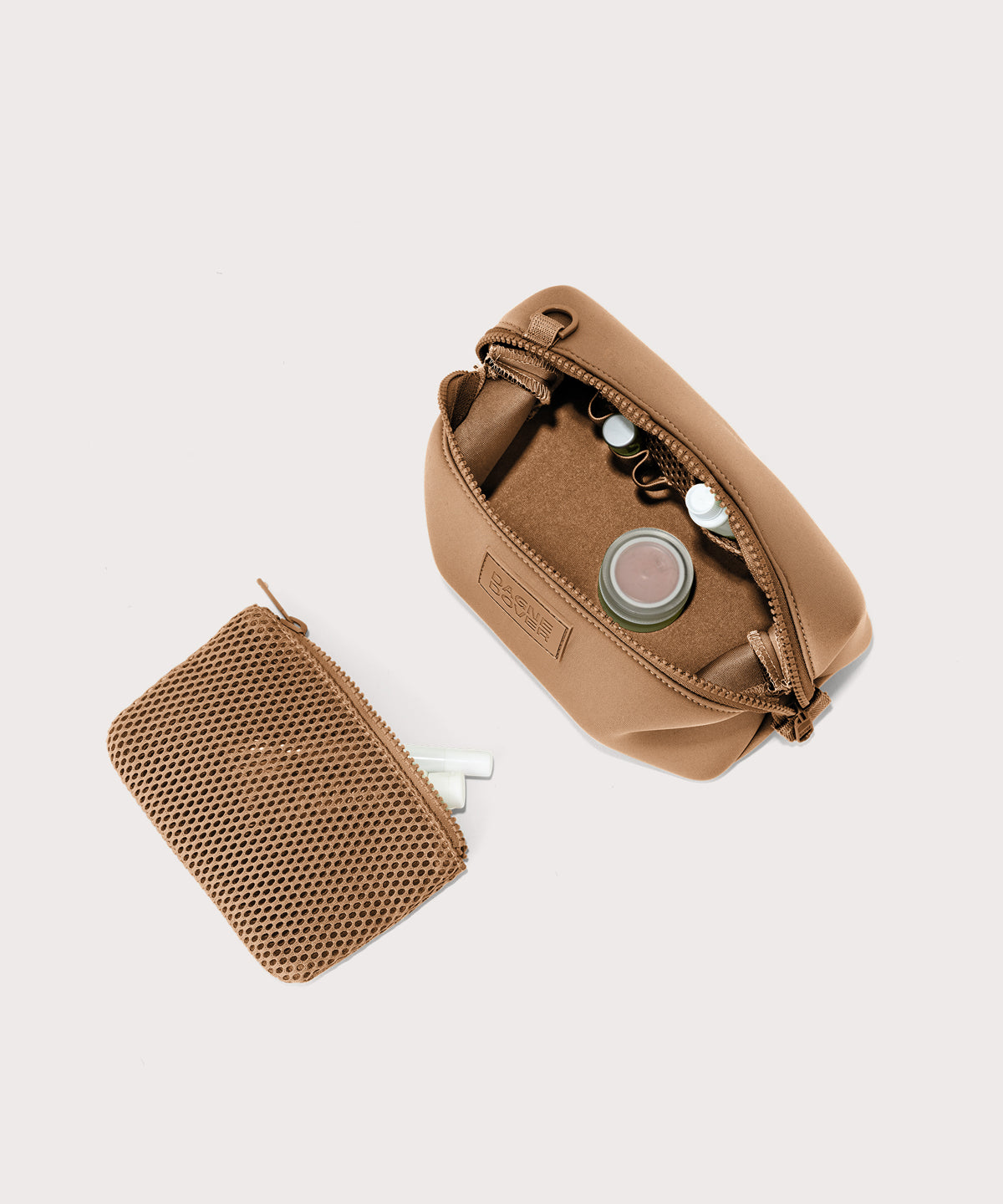 Dagne Dover Small Hunter Toiletry Bag in camel unzipped and seen from above with the removable air mesh pouch alongside it.