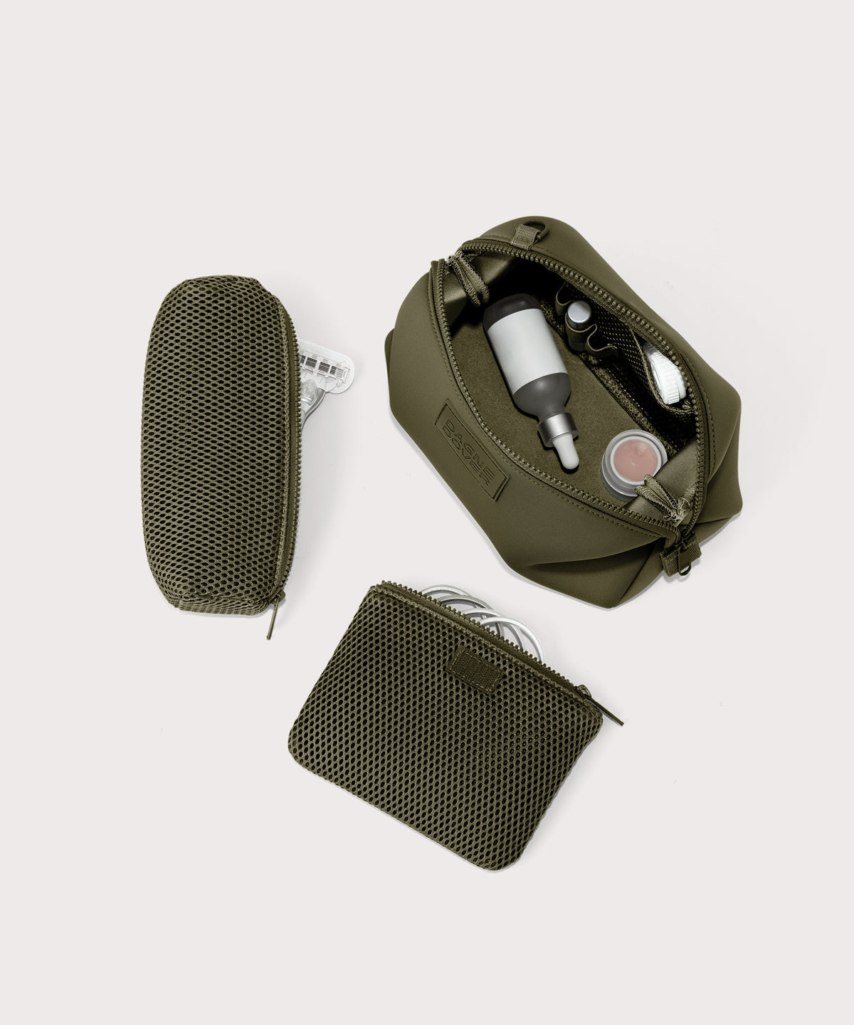 Dagne Dover Large Hunter Toiletry Bag in dark moss unzipped and seen from above with the removable air mesh pouch alongside it.