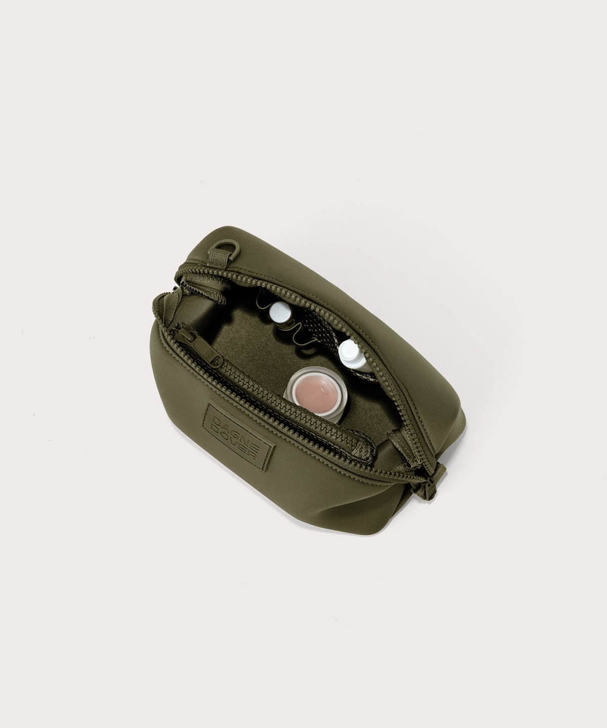 Dagne Dover Small Hunter Toiletry Bag in dark moss unzipped and seen from above.
