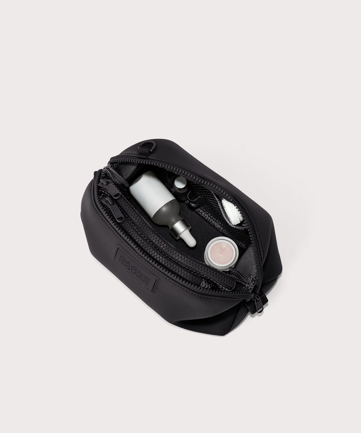 Dagne Dover Large Hunter Toiletry Bag in black unzipped and seen from above.

