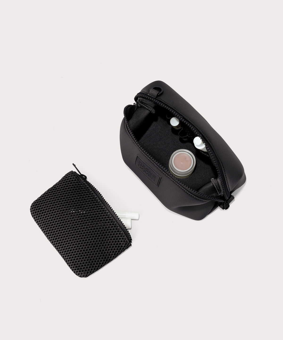 Dagne Dover Small Hunter Toiletry Bag in black unzipped and seen from above with the removable air mesh pouch alongside it.