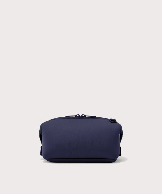 Dagne Dover Small Hunter Toiletry Bag in dark blue seen from the back.
