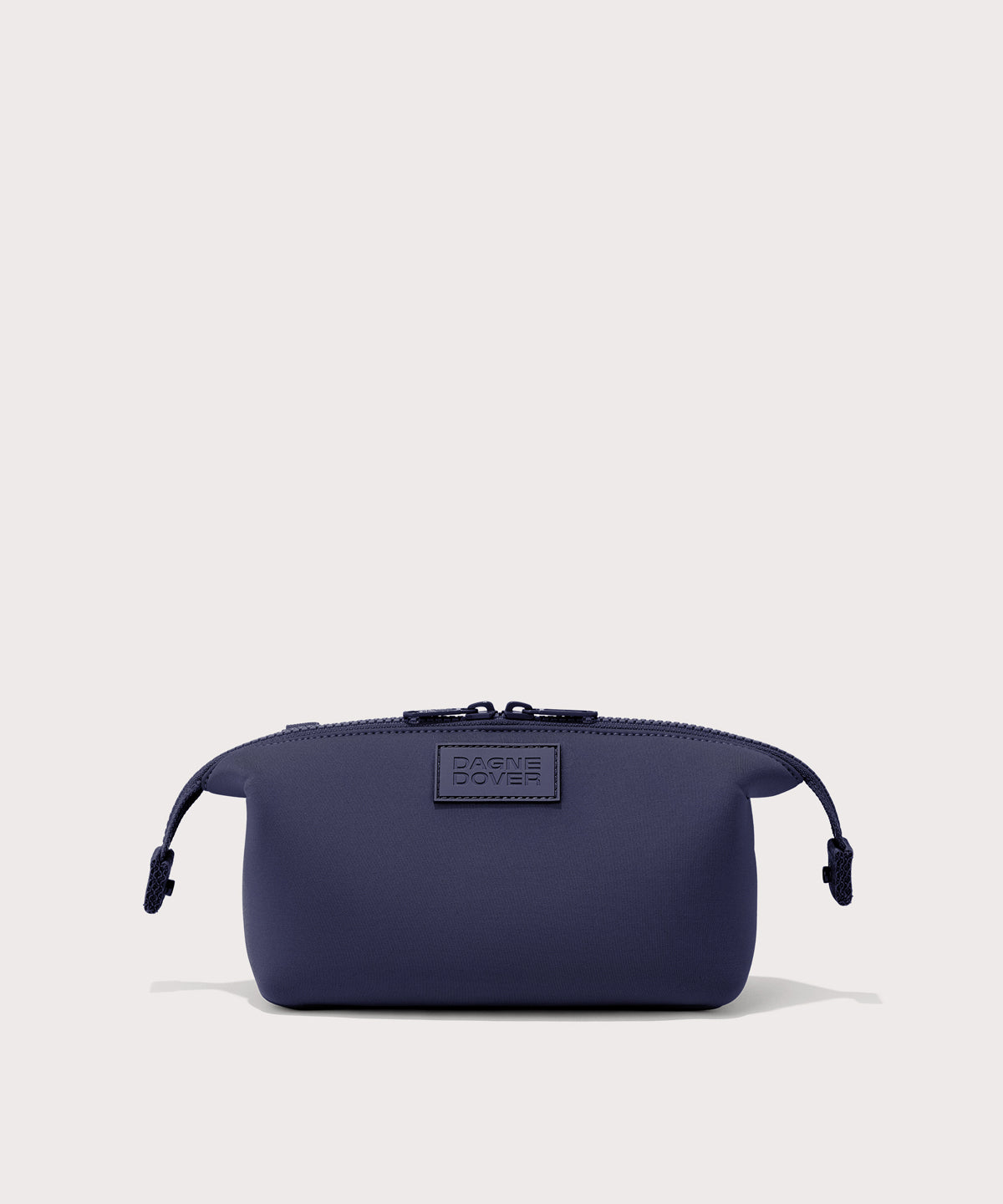Dagne Dover Small Hunter Toiletry Bag in dark blue with sides unclipped.
