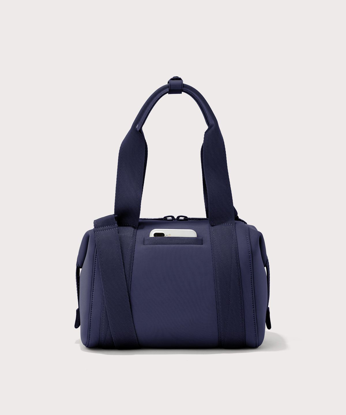 small Landon Carryall in dark blue, displaying an exterior phone pocket
