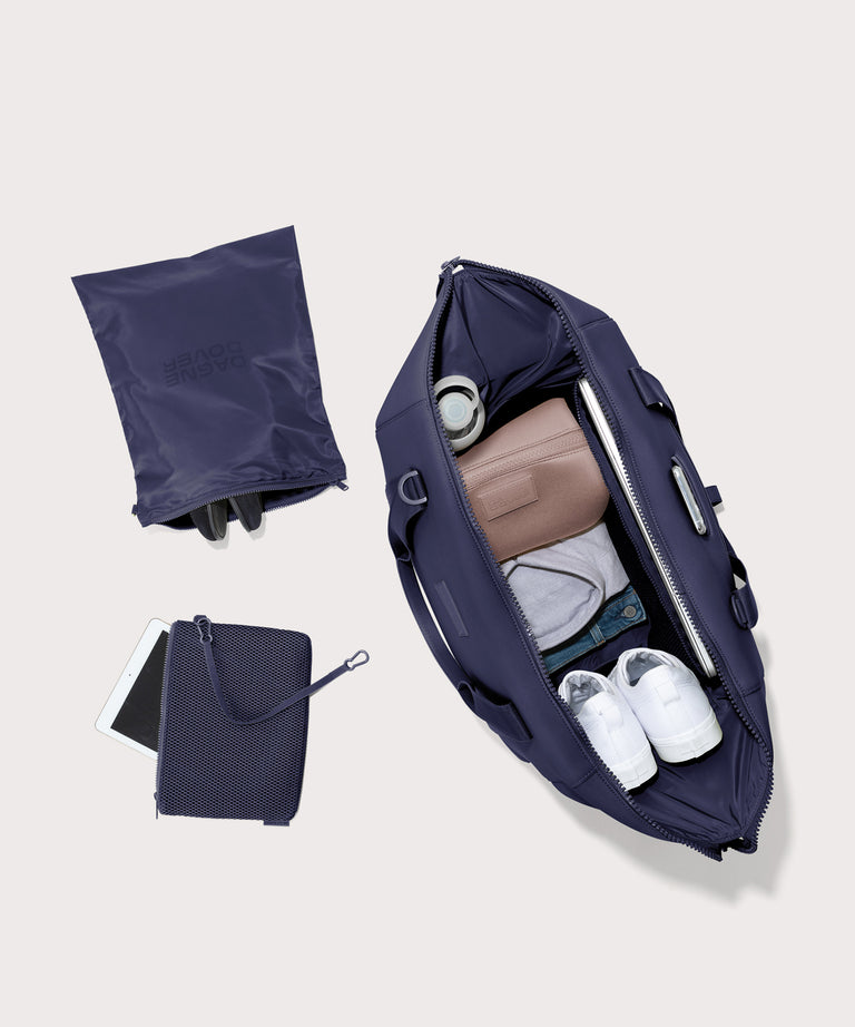 Extra large Landon Carryall in dark blue unzipped, top down view. 

