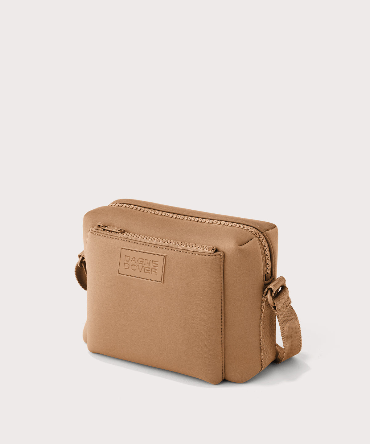 Dagne Dover Micah crossbody in brown camel seen from an angle.

