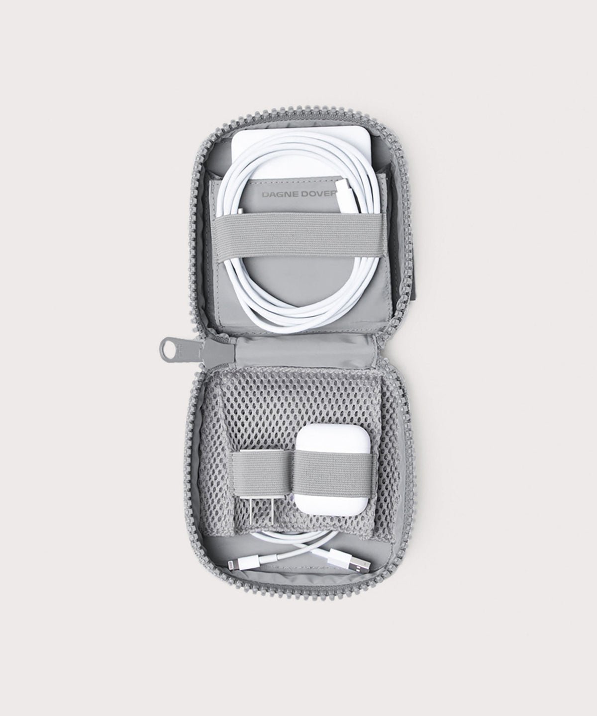 Dagne Dover small Arlo Tech Organizer in grey unzipped, revealing the interior elastic loops and airmesh pockets.
