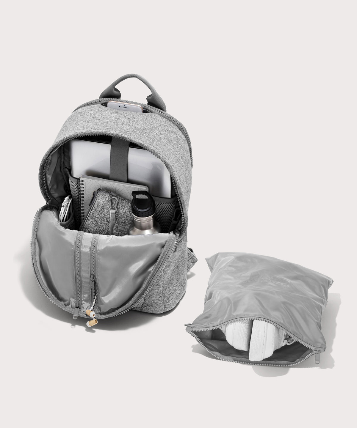 Dagne Dover large Dakota Neoprene Backpack in grey unzipped, showing the interior pockets and shoe bag.
