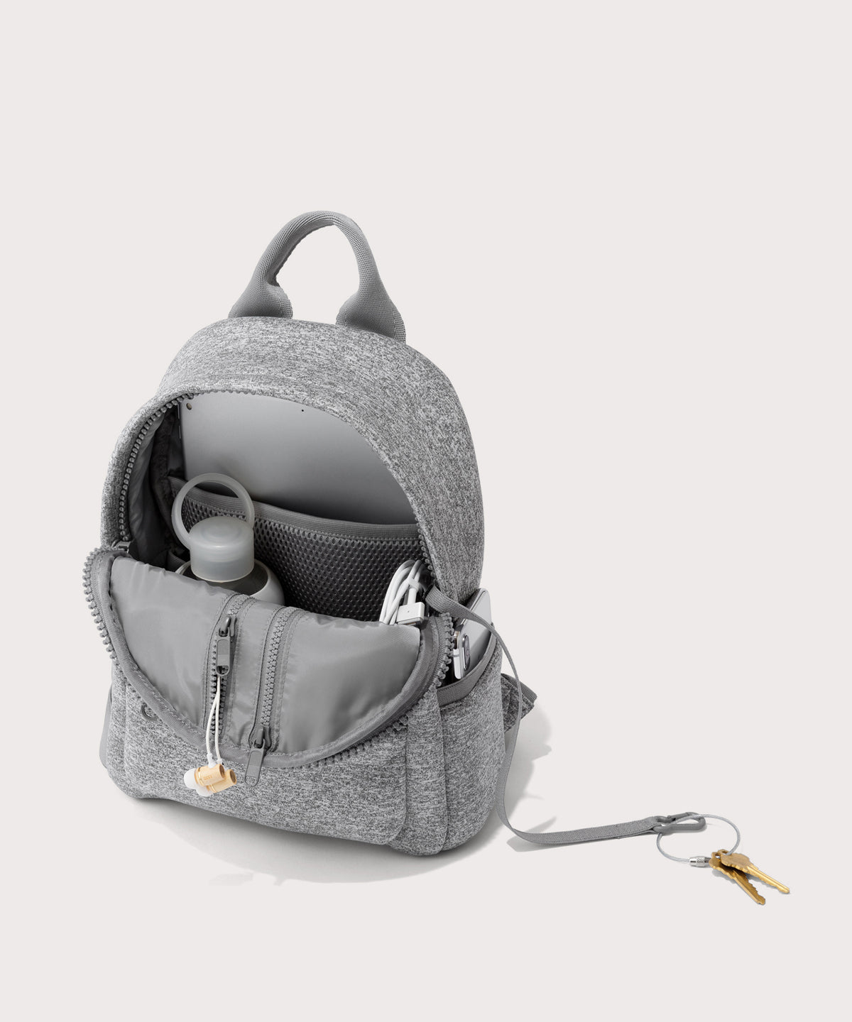 Dagne Dover Dakota Small Neoprene Backpack in grey unzipped, revealing the interior air mesh pockets.