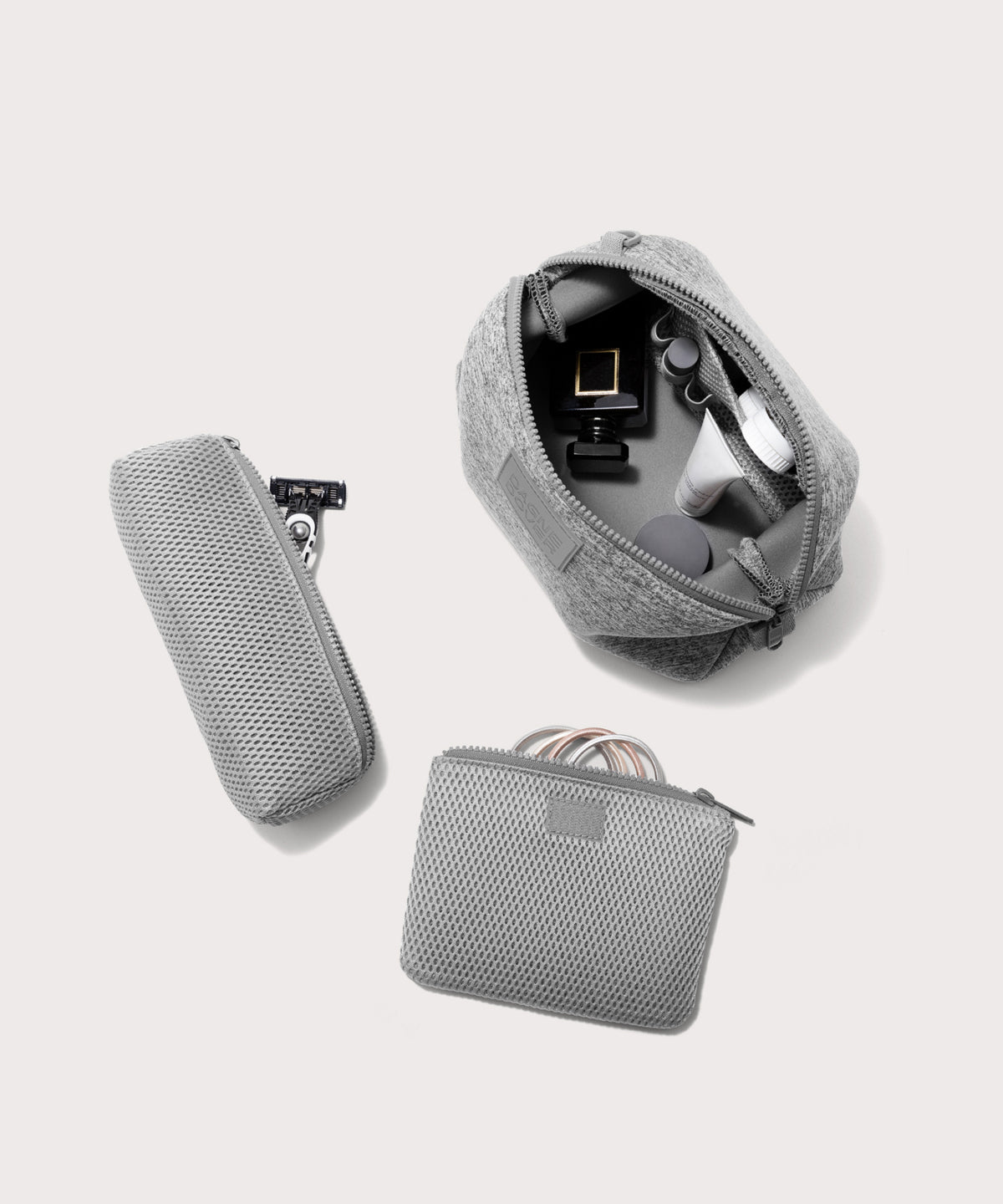 Dagne Dover Large Hunter Toiletry Bag in grey unzipped and seen from above with the removable air mesh pouch alongside it.