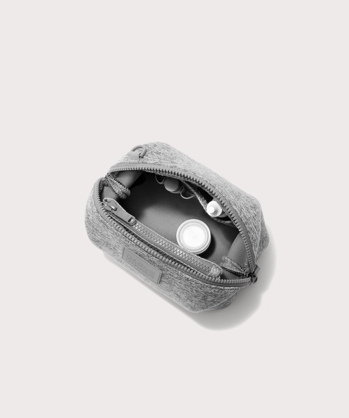 Dagne Dover Small Hunter Toiletry Bag in grey unzipped and seen from above.
