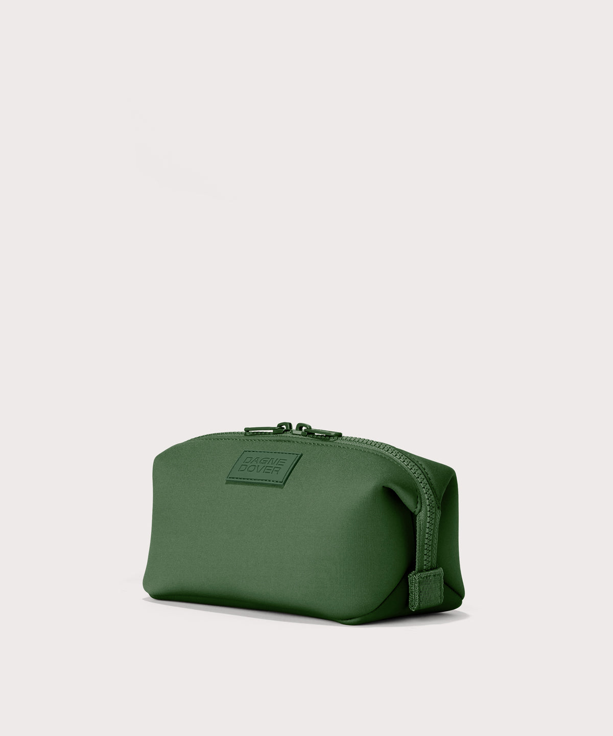 Dagne Dover Small Hunter Toiletry Bag in a rich, classic forest green seen from an angle.
