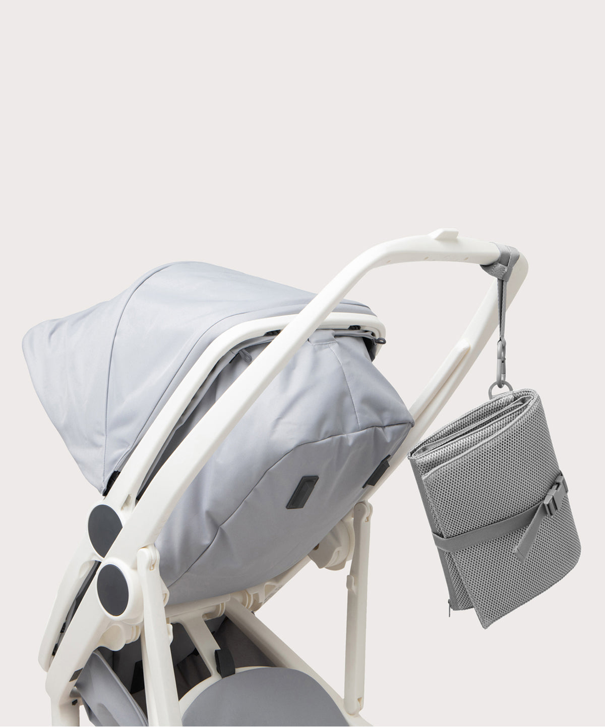 Dagne Dover Joey Changing Kit in grey strapped to the handle of a stroller.
