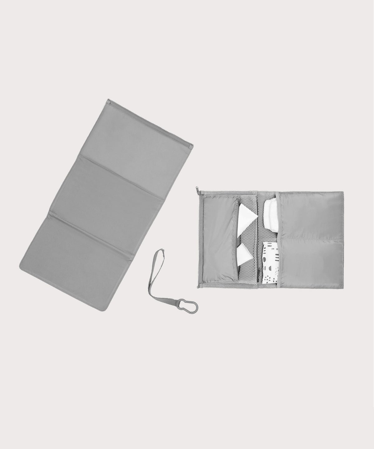 Dagne Dover Joey Changing Kit in grey unfolded, revealing the interior zipper pocket and interior slip pockets.

